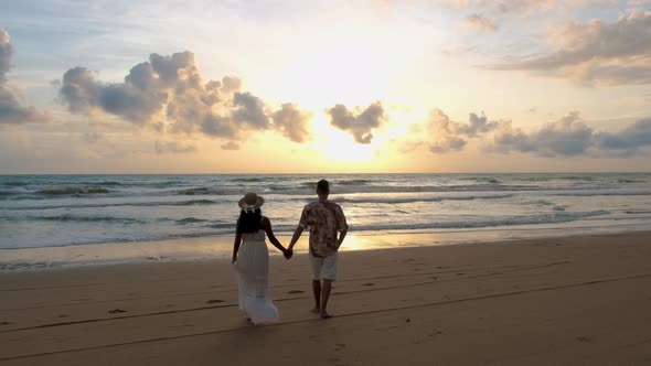 Couple Men and Woman Walking on the Beach During Sunset in Khao Lak Thailand