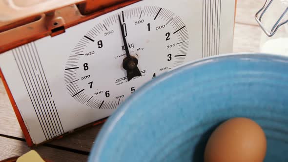 Clock and brown eggs on wooden table