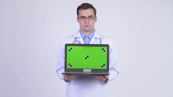 Young Happy Handsome Man Doctor Showing Laptop