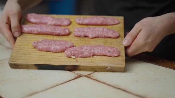 Detail Shot of Unrecognizable Chef Showing Meat on Cutting Board in Slow Motion