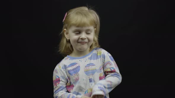 Little Baby Girl in Pajama Eats Porridge From the Spoon