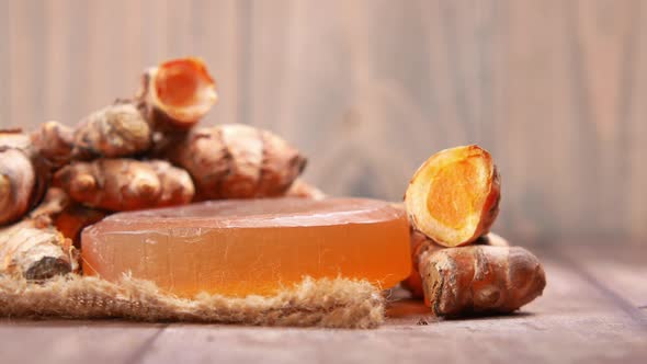 Turmeric Root and Herbal Soap on Table