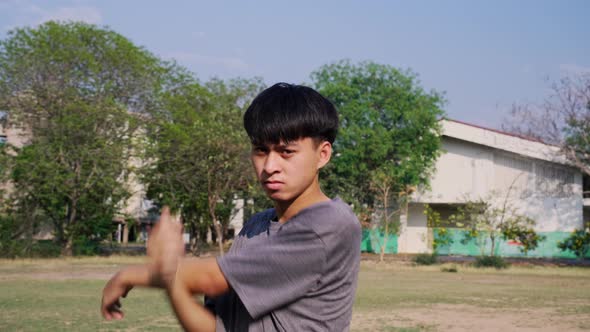 Healthy young man stretches to warm up before running in the park.