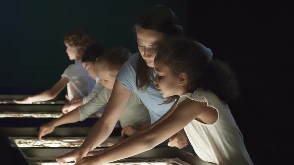 Teacher Helping Girl Making Sand Animation alt