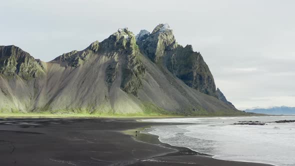 Drone Of Man On Black Beach Under Vestrahorn Mountain