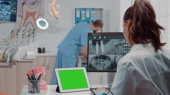 Orthodontist Using Horizontal Green Screen on Tablet