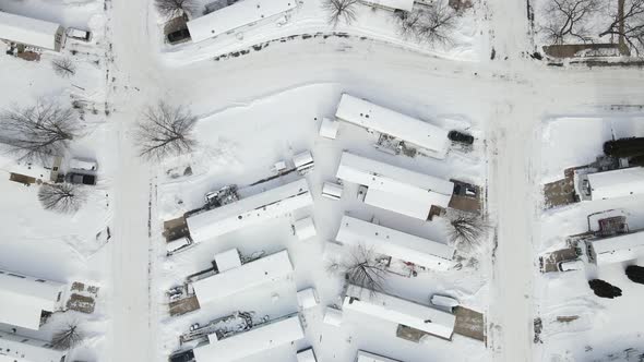 Top down view over snow covered mobile home park on quiet winter day in Wisconsin.
