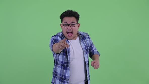 Happy Young Overweight Asian Hipster Man Getting Good News