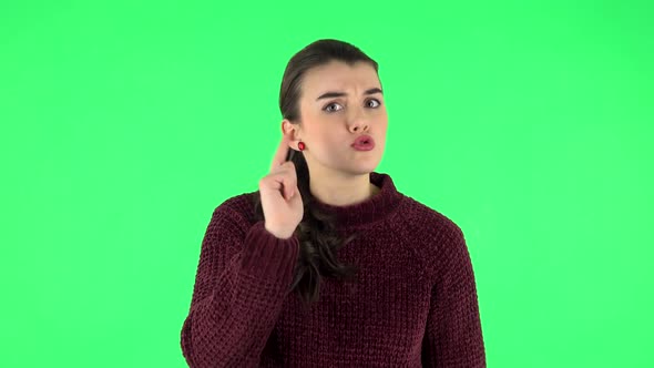 Girl Listens Carefully, Threatens with a Finger and Waves Her Head Negatively. Green Screen