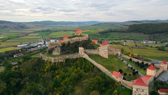 Aerial drone view of Rupea Fortress, Romania. Citadel located on a cliff, tourists