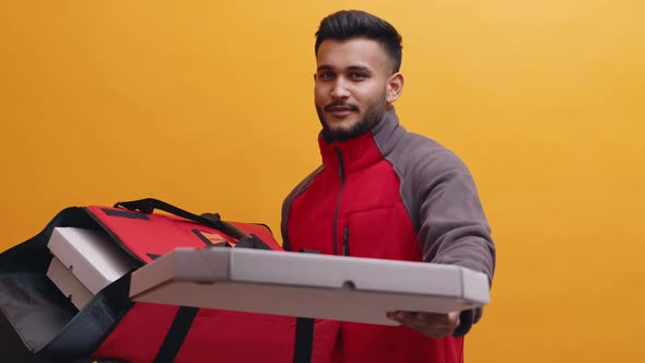 Indian Man with Food Delivery Bag in One Hand Giving Pizza to the Customer