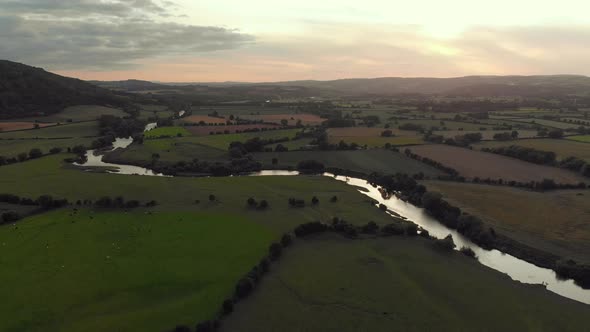 Aerial footage of the river Wye in England at sunset.