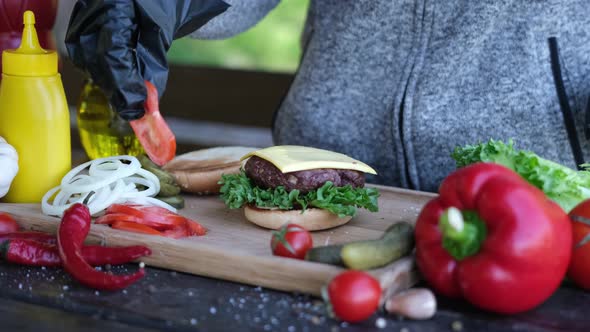 Making Burger  Putting Slices of Tomato on a Cheddar Cheese