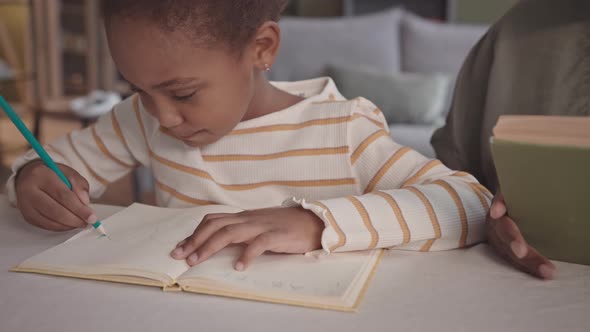 Preschool Girl Studying at Home with Mom