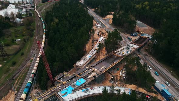 Aerial View Over Cistern Train and Cars Moving By New Bridge Construction Site