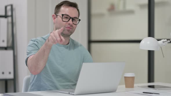 Young Man Laptop Pointing Camera