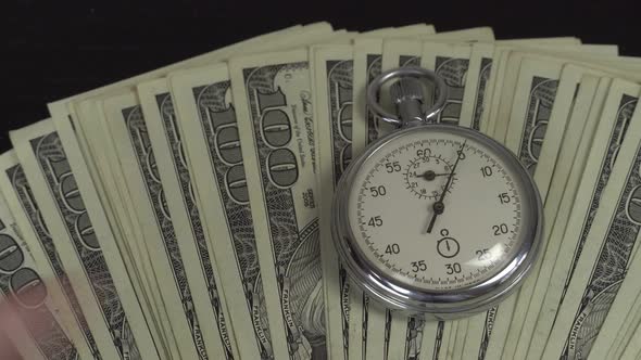 Dollars and stopwatch. Business concept of lost time and failed investments