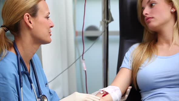 Nurse smiling to a blood donor