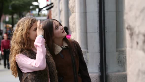 Two young women window shopping