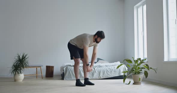 Young Bearded Man Doing Stretching Exercise, Leaning To Feet