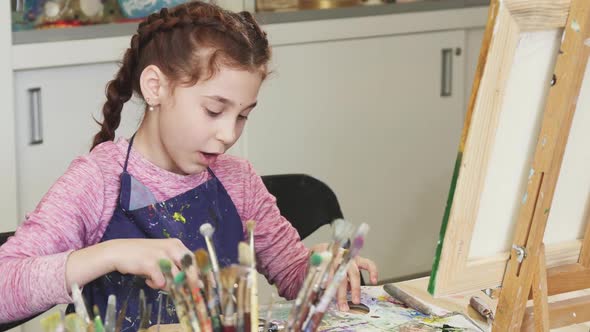 Little Happy Beautiful Girl Smiling To the Camera at the Art Studio