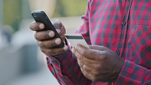 Crop Closeup of African American Man Shopping Online on Cellphone Pay with Credit Card