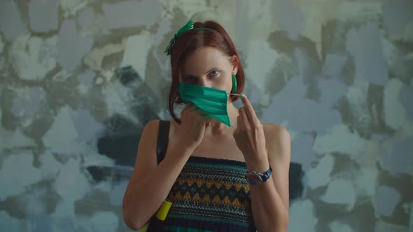 Young 30s Brunette Woman Wears Protective Face Mask, Portrait of Pretty Lady Wearing Green Facial