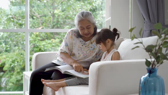 Elderly Asian Woman Teaching Her Granddaughter 04