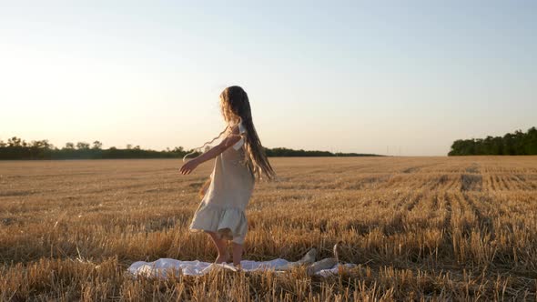 Serious Sad Girl a Child Stands on a Wheat Mown Field