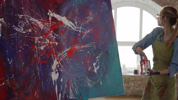 Woman Creates Masterpiece of Abstract Painting Sprinkles Paints on Canvas