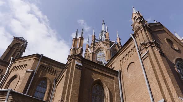 Ancient cathedral on blue cloudy sky background