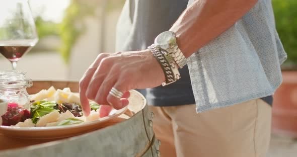 Romantic Couple, Man Eating Finger Food Cheese Appetizer at Warm sunset.Food Taken By Hand Detail