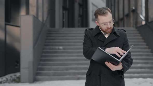 Businessman Reading Some Documents Looking Serious