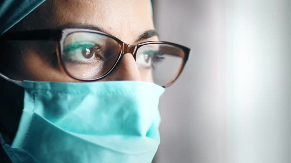 Woman doctor wearing a surgical mask and glasses