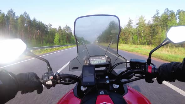 Motorcyclist Riding on the Highway. View From Behind the Wheel of a Motorcycle. POV