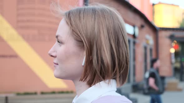 Young Woman with Short Fair Hair and Wireless Headphones