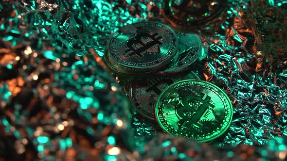 Bitcoin in Reflected Isolated Surface with Green and Gold Light. Rotating Coins. Blockchain