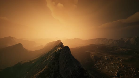 High Mountain Peaks Covered with Dramatic Heavy Fog alt