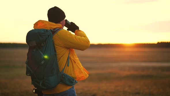 Hiker Young Tourist Enjoying Nature Drinking Hot Tea at Sunset