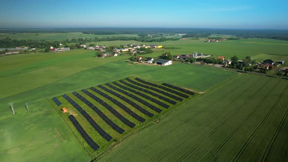 Solar Power Plant In The Green Field - aerial drone shot