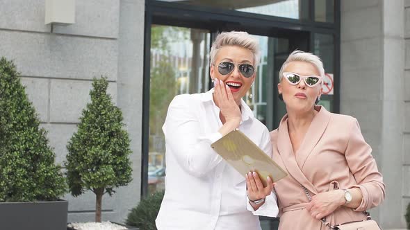 Two Businesswoman Walking on Street Near Building, Business Woman Going Together with Tablet