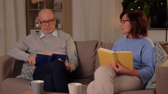 Happy Senior Couple Reading Books at Home