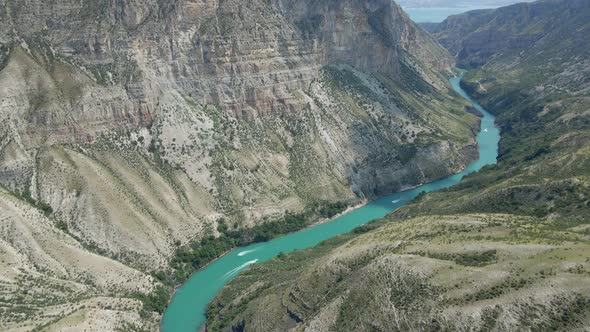 Drone Flight Over the Sulak Canyon a Long Blue River Below with Boats