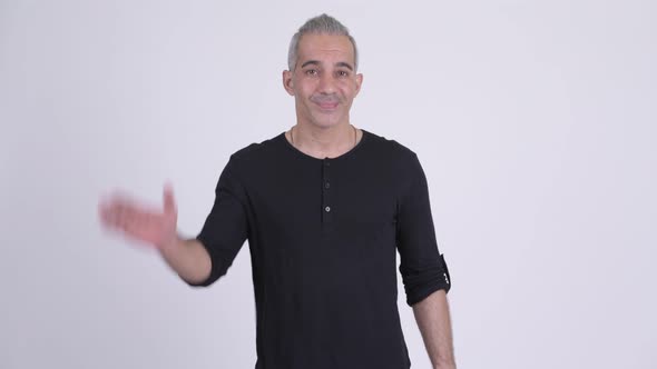 Happy Persian Man Waving Handsagainst White Background