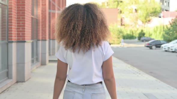 African Woman Walking on Street Back View