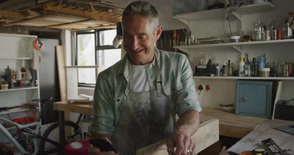 Man doing DIY at home using smartphone