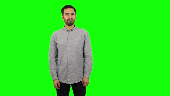 Brunette Guy Communicates with Someone in a Friendly Manner. Green Screen