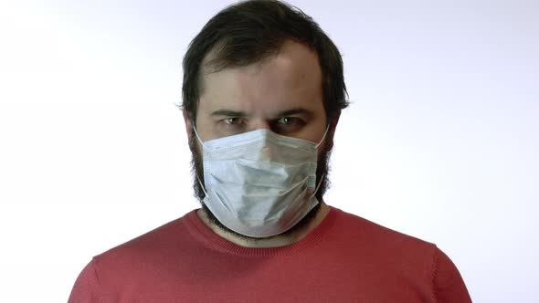 Man in Medical Mask Looks with Fear Nervously Deeply Breathes. Panic of Epidemic