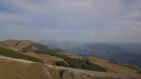 Drone view of two friends hiking in the Apennines, Umbria, Italy