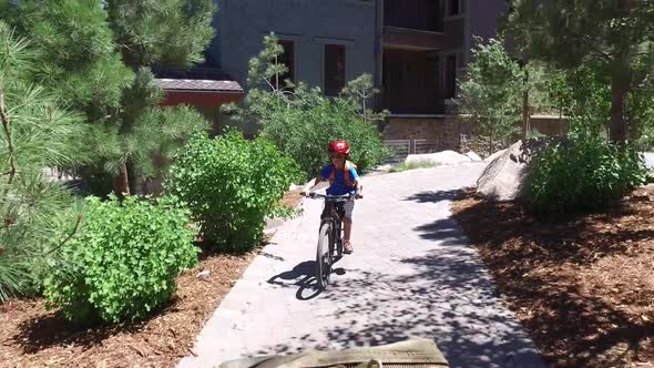 A boy rides his mountain bike on a path.